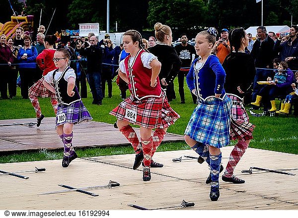 Young girls performing highland dancing at a highland games in Scotland.