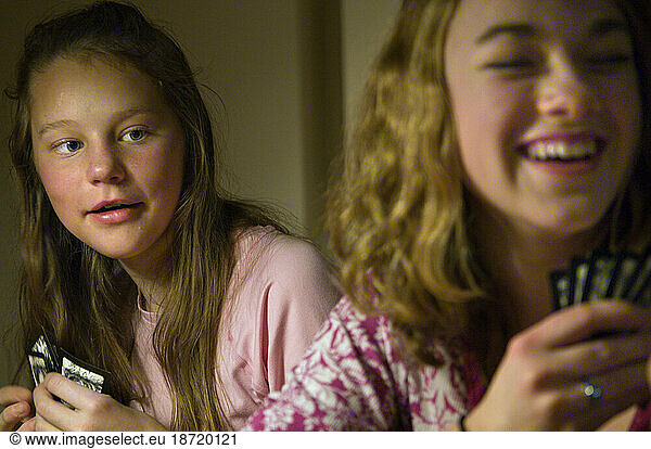 Young girls play cards during a holiday family gathering in Richfield  Minnesota.