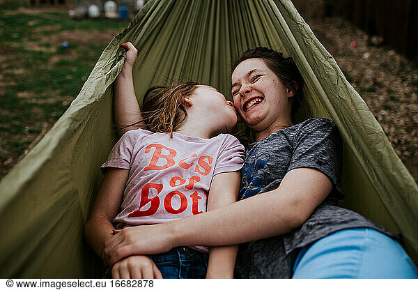 Young girls playing in hammock outside