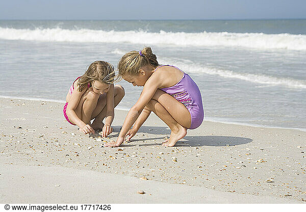 Young Girls Playing With Seashells