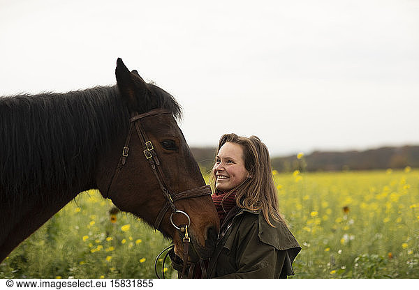 young horsewoman with a horse outeside