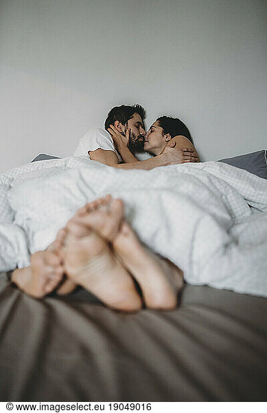 Young loving couple in the bed in the morning