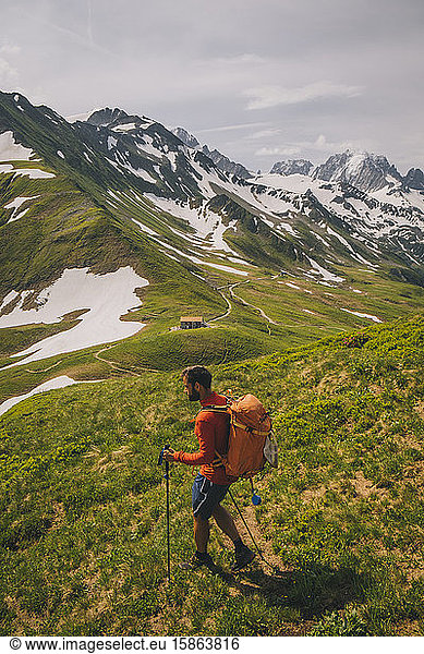 Young male hiking in the French alps between France and Switzerland