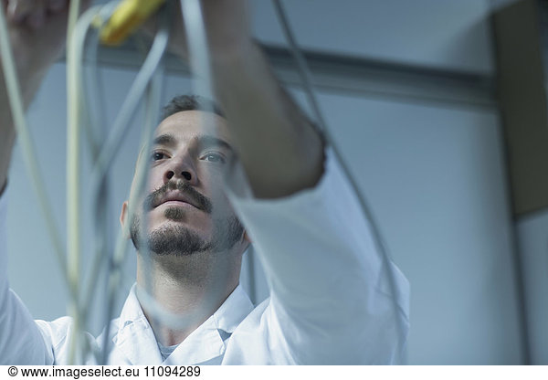 Young male scientist working in a pharmacy laboratory