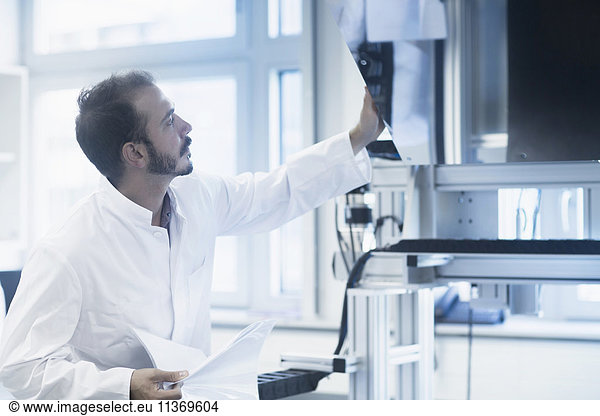 Young male scientist working in technology space