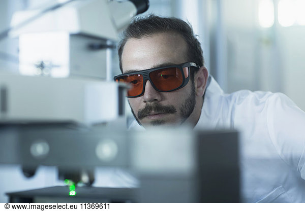 Young male scientist working in technology space