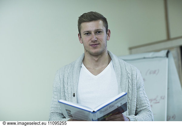 Young male teacher teaching in classroom  Freiburg Im Breisgau  Baden-Württemberg  Germany