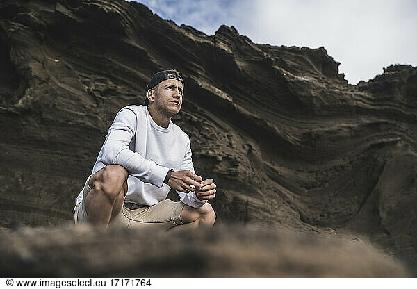 Young male tourist looking at view in El golfo during vacations  Lanzarote  Spain
