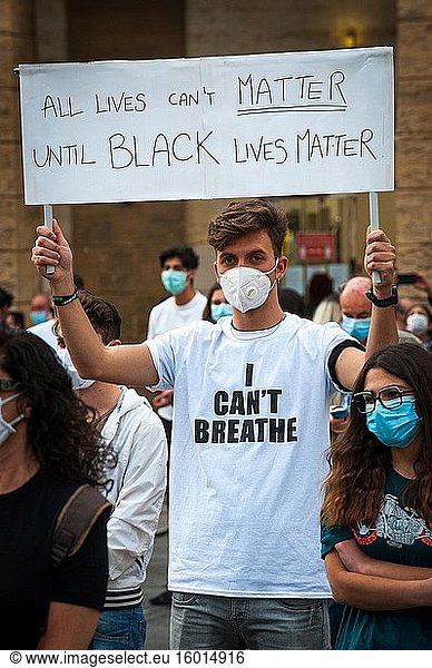 Young man activist with surgical mask at a 'Black Lives Matter' flash mob.