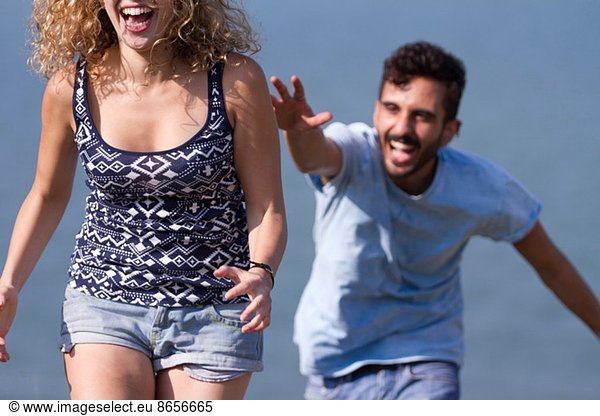 Young man chasing woman  laughing