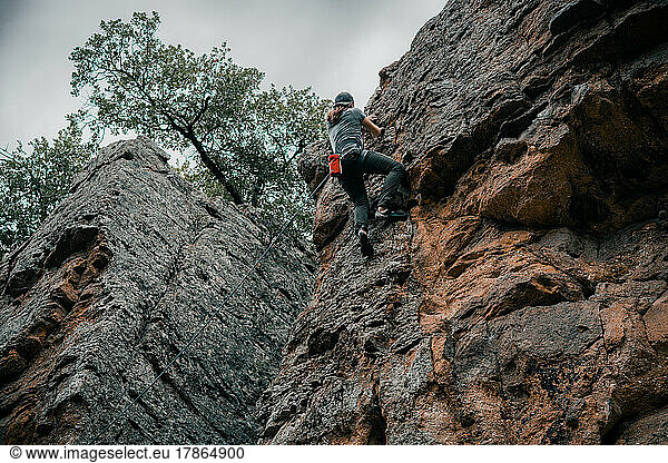Young man climbing up a cliff at Lake Mineral Wells State Park