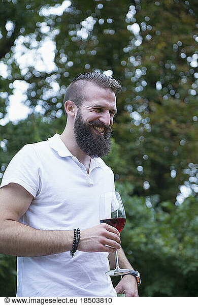 Young man enjoying red wine at picnic  Bavaria  Germany
