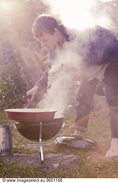 Young man having barbecue