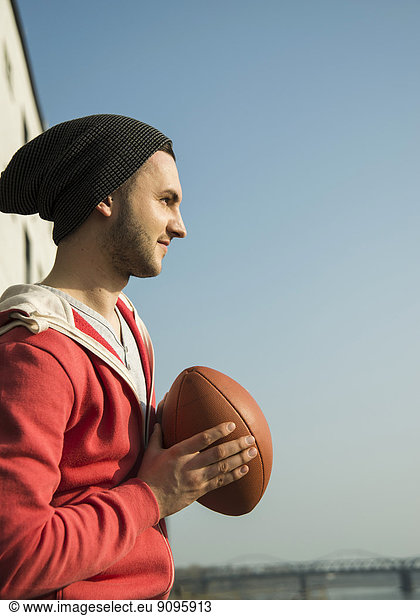 Young man holding football