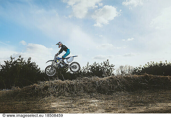 Young Man in air on Dirt Bike Jump