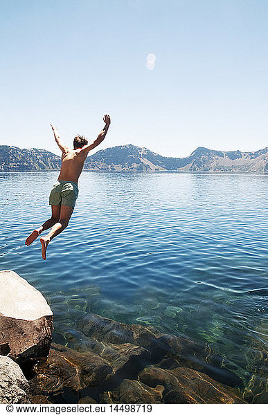 Young Man Jumping into Lake