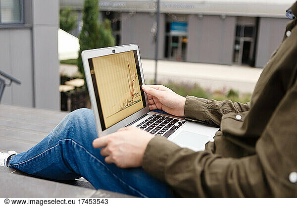 young man on a laptop is engaged in stock trading
