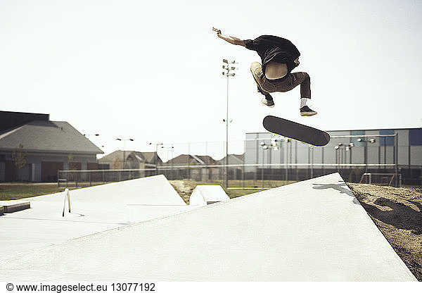 Young man performing stunts on skateboard