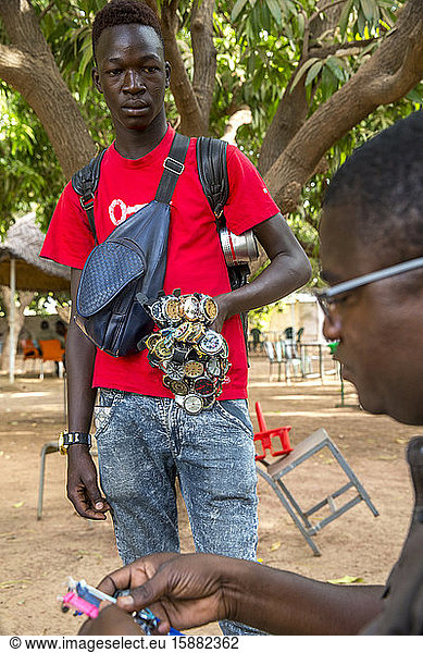 Young man selling watches in Koudougou  Burkina Faso.