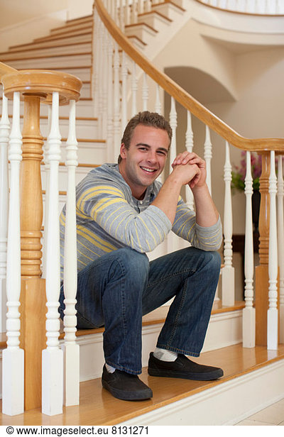 Young man sitting on stairs