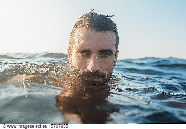 Young man swimming in the sea
