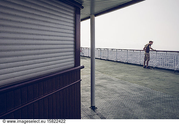 Young man watching the sea  standing on a ferry  Canary Islands  Spain
