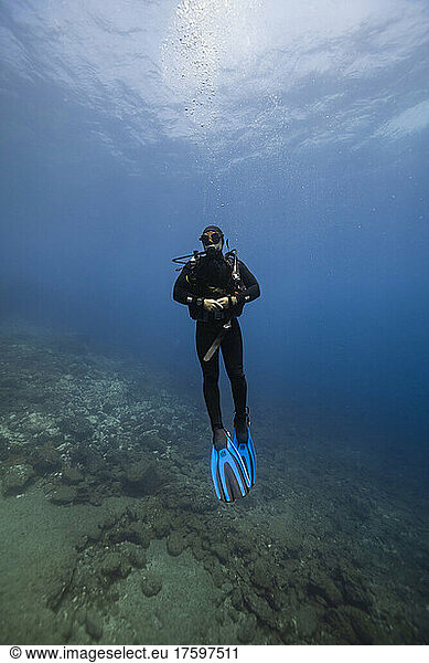 Young man wearing diving equipment undersea