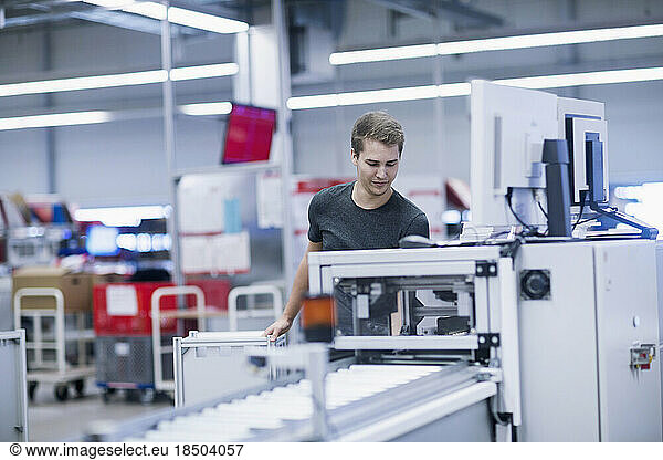 Young man working in books printing industry  Bremgarten  Hartheim am Rhein  Baden-Wuerttemberg  Germany