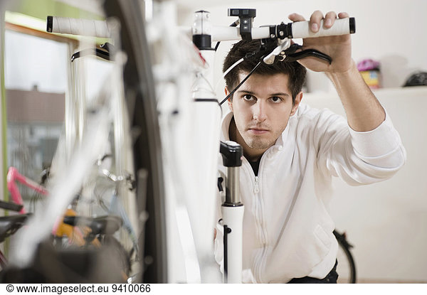 Young man working on bicycle