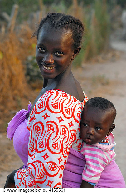 Young mother with her child on her back  Tanji  The Gambia  Africa