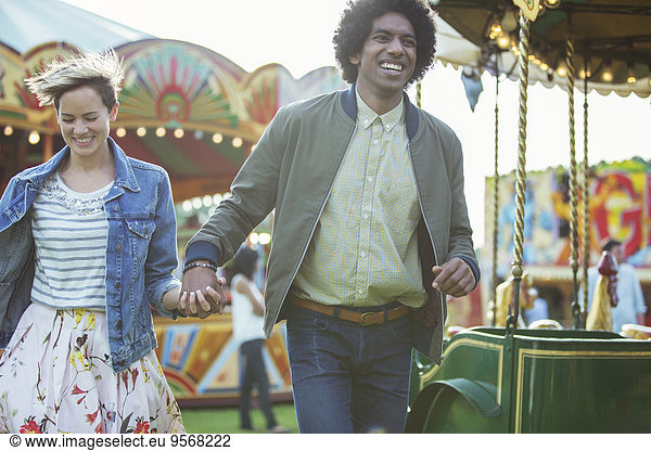 Young multiracial couple having fun in amusement park
