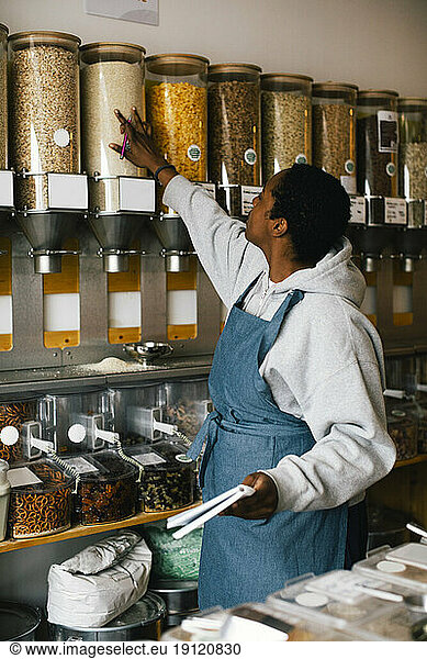 Young owner checking inventory in food store
