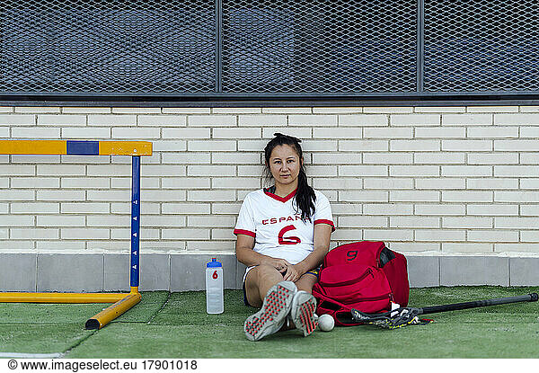 Young player resting on sports field