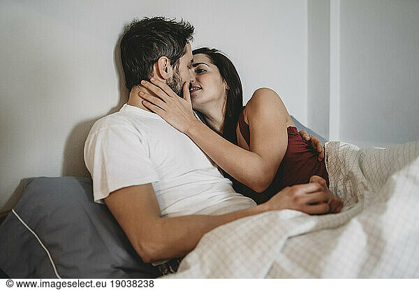 Young romantic couple in bed