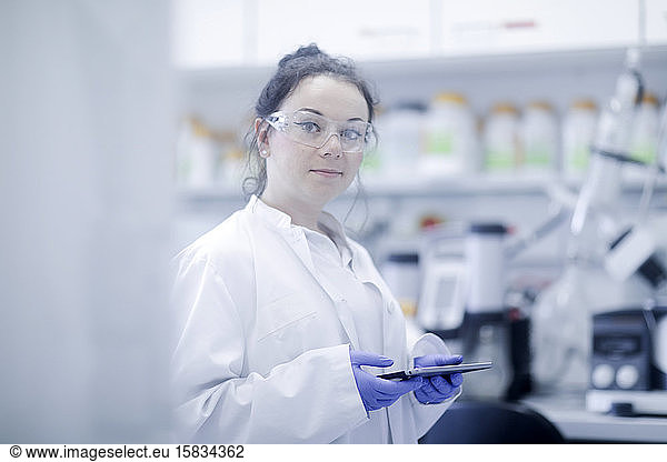 young scientist female with tablet in a laboratory