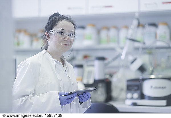 young scientist female with tablet in a laboratory