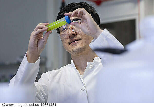 young scientist male chinese working in laboratory
