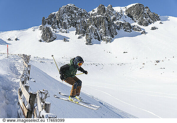Young tourist skiing on snowcapped mountain