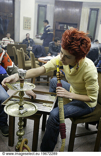 Young Turkish woman with her Nargile (Bubble Pipe) inside Corlulu Ali Pasha traditional cafe. Istanbul  Turkey