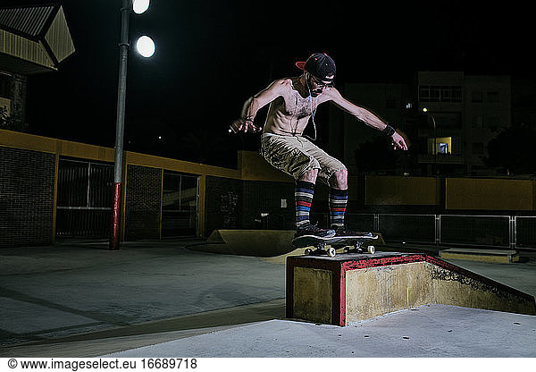 young white man jumping on his skateboard