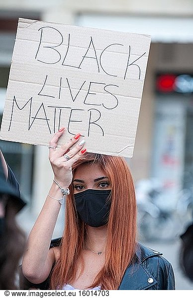 Young woman activist with surgical mask at a 'Black Lives Matter' flash mob.