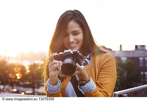 Young woman adjusting camera