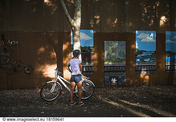 Young Woman admiring public art on Cape Cod bike path