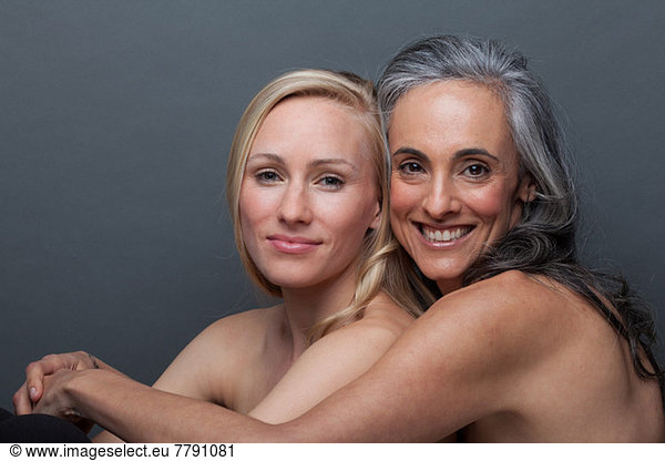 Young woman and mature woman hugging
