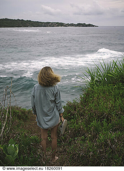 Young woman at ocean coastline