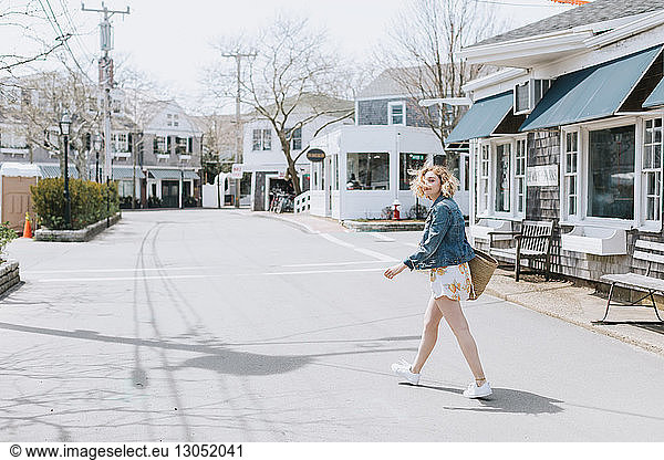 Young woman crossing road  portrait  Menemsha  Martha's Vineyard  Massachusetts  USA