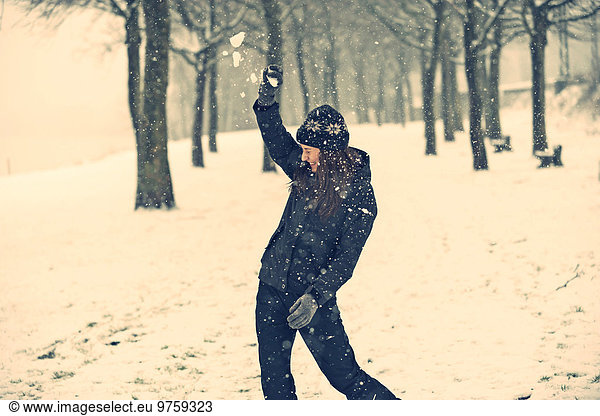 Young woman defending snowball