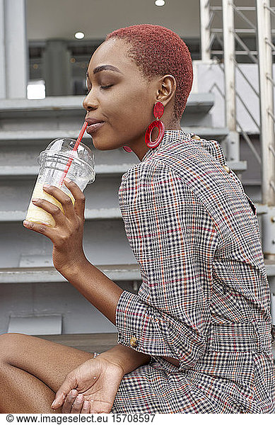 Young woman drinking a cold drink  closed eyes