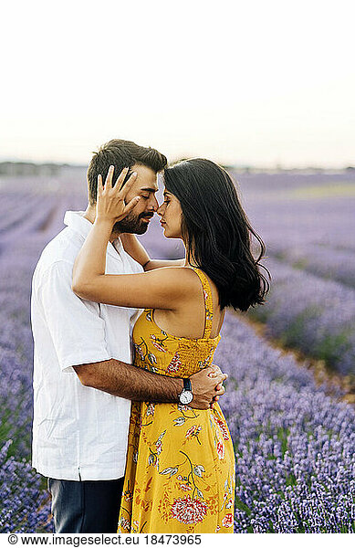 Young woman embracing man in field