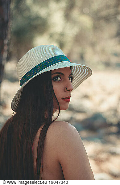 Young woman enjoying a sunny day in a mediterranean forest